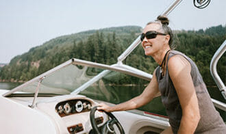 mature woman driving speed boat