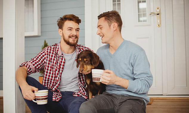 couple drinking coffee on front porch