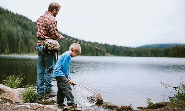 fahter and son fishing in a lake