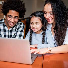family looking at laptop computer